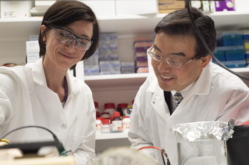 Shin-Ichiro Imai, MD, PhD, and Alessia Grozio, PhD, study in the lab.